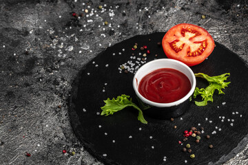 tomato sauce in bowl with fresh tomatoes on a dark background, Food recipe background. Close up