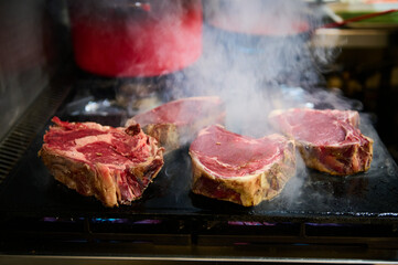 Thick beef steaks on the grill