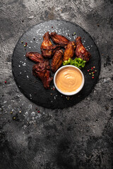 barbecue chicken wings, Baked chicken wings with sauce. Food background, vertical image. top view. place for text