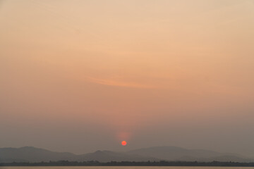 Sunrise with clouds and blue sky background. Nature and outdoor background in water reservoir at Thailand