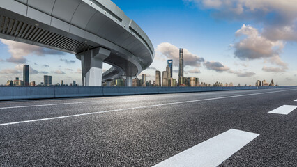 Asphalt highway and city skyline with modern buildings in Shanghai, China.