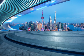 Empty square floor and city skyline with buildings in Shanghai at night, China.