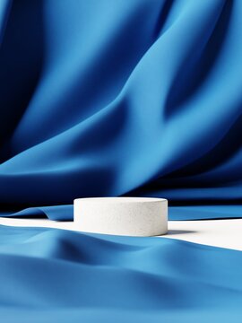 3d rendering of empty white cylinder product display podiums for advertising on blue fabric background and foreground. 3d illustration.