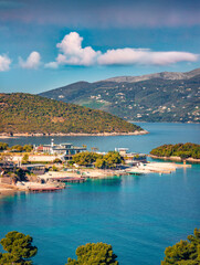 Fototapeta premium Aerial seascape of Ionian sea with Corfu island on background. Adorable summer view of Ksamil village. Stunning outdoor scene of Albania, Europe. Traveling concept background.