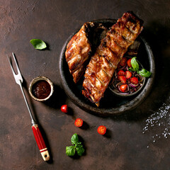 Grilled pork bbq ribs served with cherry tomatoes