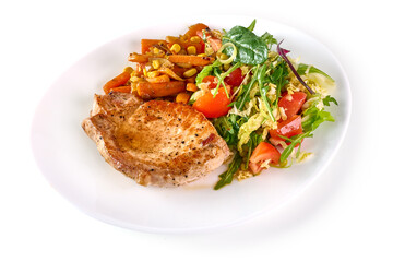 Grilled juicy pork steak with vegetable salad, close-up, isolated on white background.