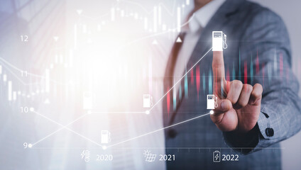 Oil energy graph of the world market, impact on the economy concept, Businessman touch chart with the indicator on the oil price slide at gas station, fluctuations in oil prices and exchange trade.