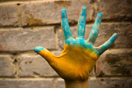Hand painted in yellow and blue isolated on brick wall background