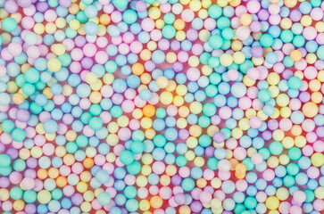 Fototapeta na wymiar Foam beads of various colors brightly colored background.