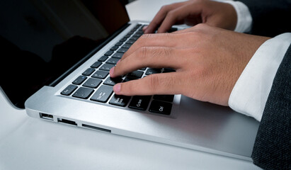 Close up, Businessman touching laptop keyboard.