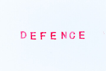 Red color ink rubber stamp in word defence on white paper background