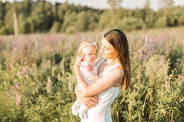 mother holds her child in her arms, nature, calm atmosphere