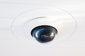 CCTV camera on the hull of an expensive motor yacht. CCTV camera white on a white body.