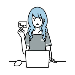 デスクで座ってPCを使いながらクレジットカードを手に持っているエステ店員・受付の女性