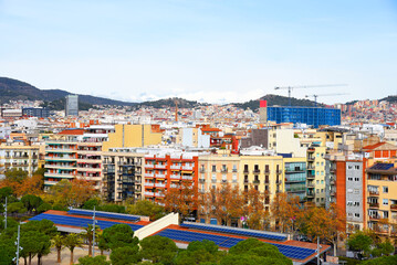 Panoramic aerial view of the city of Catalonia, Barcelona, Spain. Travel landscape. Roofs and facades of residential buildings. Panorama of the houses against the background of mountains.