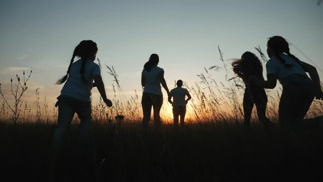 happy family. people in park children a kid together run in park at sunset silhouette. mom dad daughter and son run. happy family and little baby child summer. fun kid dream concept. children run