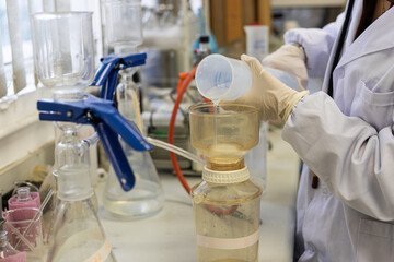 lady scientist filter water in laboratory before advanced chemical analyzes