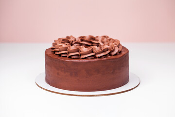 Homemade chocolate cake topped with whipped ganache