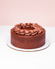 Homemade chocolate cake topped with whipped ganache