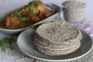 Soft flat bread made of pearl millet flour. Served with chicken in cashew gravy garnished with fresh coriander leaves