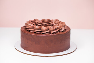Homemade chocolate cake topped with whipped ganache