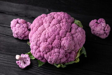 Purple colourful cauliflower on black wooden table