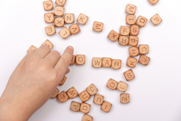 War. No war. Child's hands collect cubes form the word No War. Concept against war. Save the world