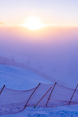 Ski slopes and Ski lifts. Small pine trees with snow. Mountain skiing and snowboarding. View of Erzurum city from Palandoken mountain