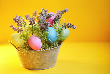 easter still life. Yellow background. Christianity. Multicolour easter eggs. Celebrate holidays. Spring 