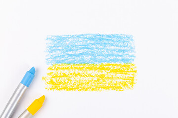 Ukrainian flag painted on white paper with wax crayons
