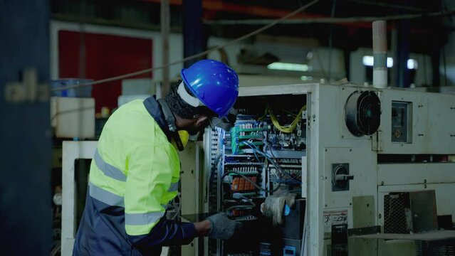 African American technician workers working in heavy industry , innovative industry standard, applying technology to replace human labor
