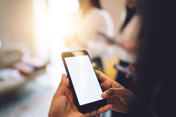 Black person browsing smartphone in office