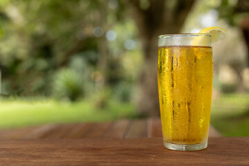 cold glass of cider with lemon