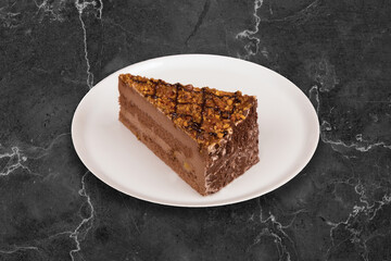Gingerbread cake with chocolate icing and hazelnuts on top