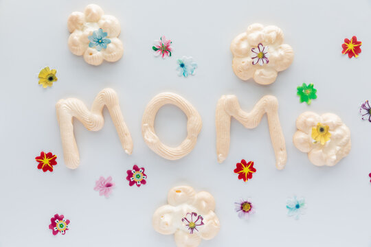 Top down view of the word Mom made from homemade meringues for Mother's Day.