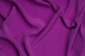 Smooth elegant purple silk or satin luxury cloth texture can use as abstract background.