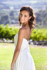 Looking like a true bride. Gorgeous young bride outdoors in her wedding dress.