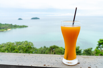 Orange juice with sea background