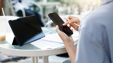 Young asian woman using personal mobile phone for freelance job and working part time, online education or online shopping, person working with online technology in modern world concept.