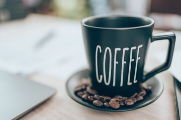 Cup of coffee on office desk and company data, document and report on the table. Accounting business concept.