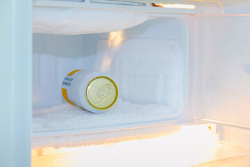 cans of beer were immersed in the freezer of the refrigerator,