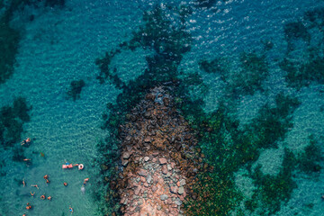 Naklejka na ściany i meble Beach and waves from top view. Turquoise water background from top view. Summer seascape from air. Top view from drone. Travel concept and idea