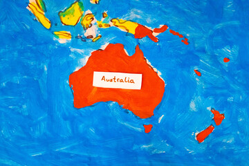 Silhouette of Australia drawn by children with label.