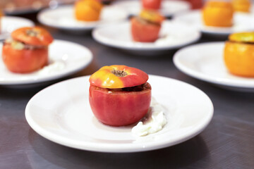 Closeup of plates with stuffed tomatoes 