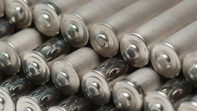 AA batteries background closeup pan slide