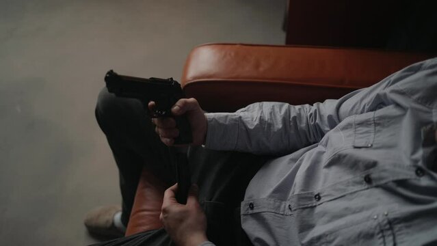 Special secret agent is reloading pistol gun. Spying or intelligence gathering. Espionage concept.