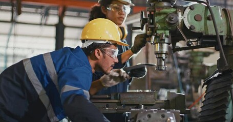 Blue-collar Worker. team of technician and engineer are checking machinery in operation in industrial plant team work of repair inspector complete maintenance of machine equipment