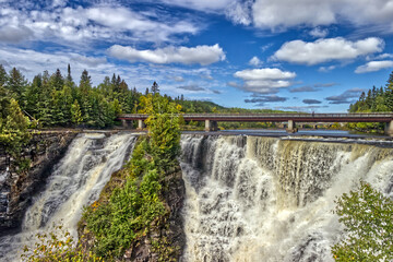 The clouds popping up from the sky above the falls - Kakabeka Falls, Thunder Bay, ON, Canada
