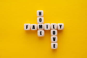 The word family over wooden cubes, yellow background