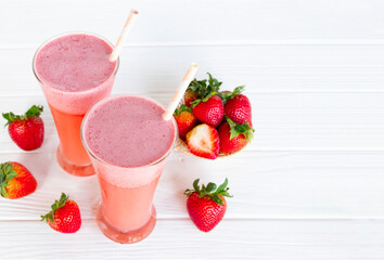Strawberry yogurt fruit juice smoothie pink colorful fruit juice milkshake blend beverage healthy high protein the taste yummy In glass drink episode morning on white wood background.
